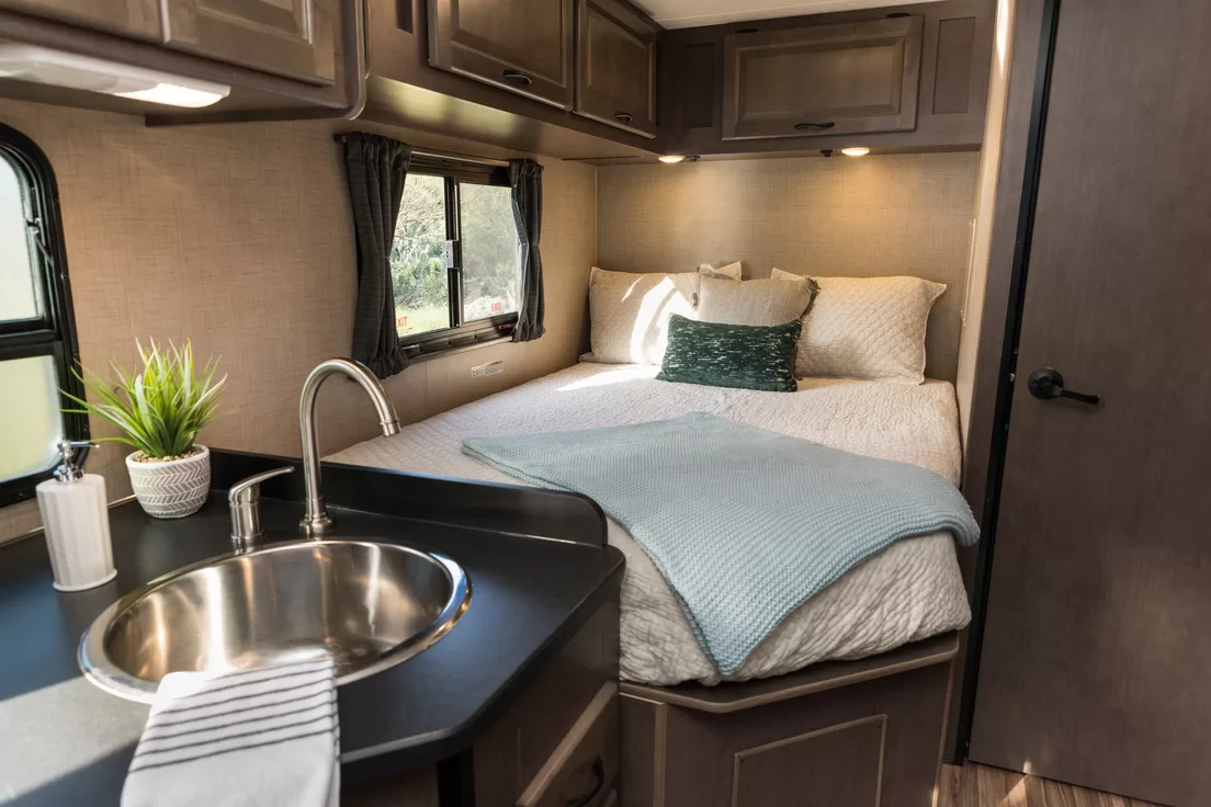 Het interieur van een Cruise America camper, met een tweepersoonsbed zichtbaar
