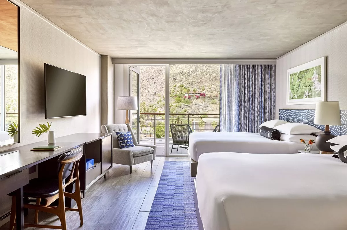Kamer met twee aparte bedden en een balkon in het Hotel Kimpton Palm Springs