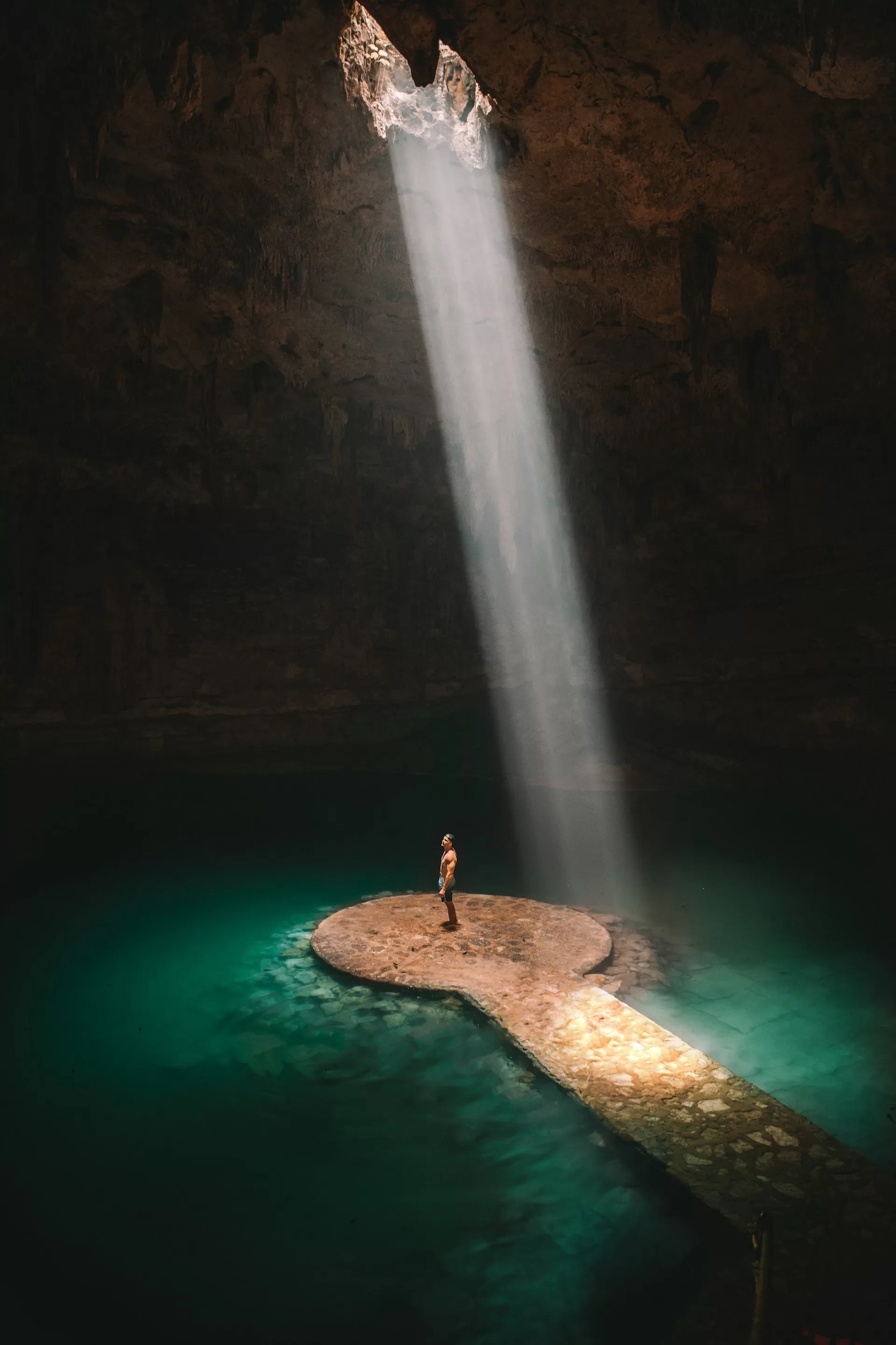 Zonnestraal op het turquoise water in een cenote bij Tulum, Mexco