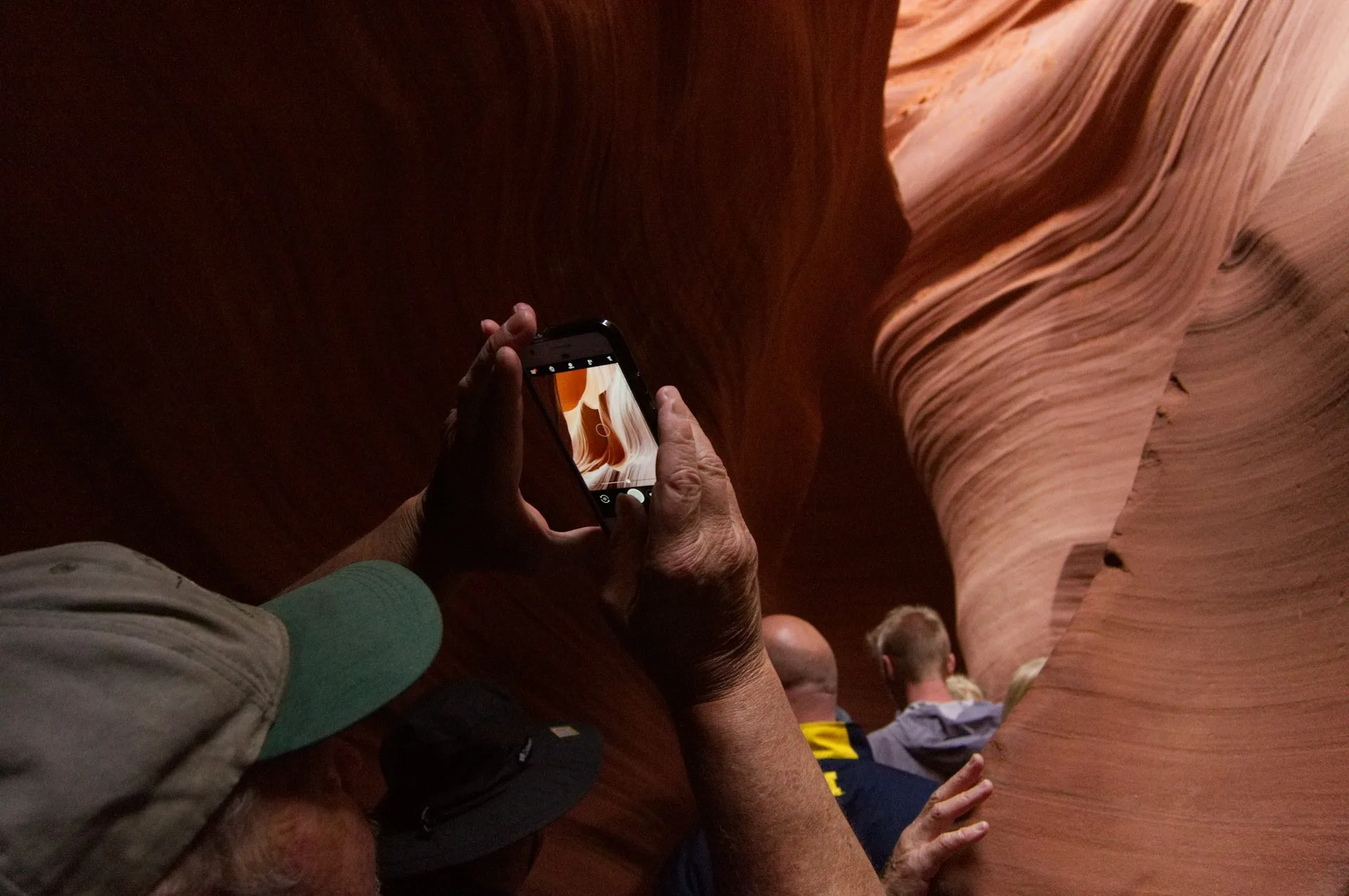 Wanderer erkunden die engen, orangefarbenen Felsformationen des Antelope Canyon in Arizona